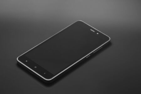Smartphone in a black metal case on a black background