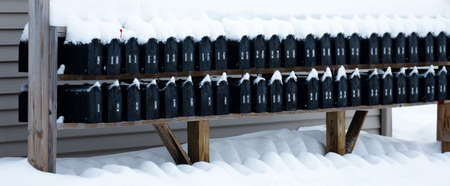 Mailboxes lined up in a row covered with snow