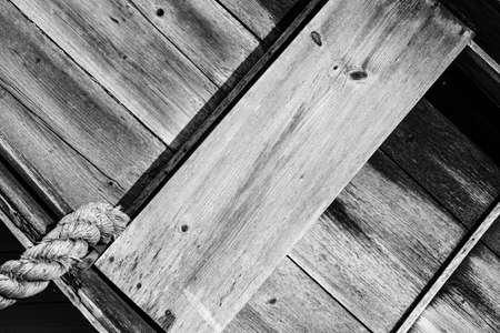 Old weathered boat with large anchor ropeの写真素材