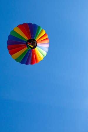 Colorful hot air balloon floating in a clear blue sky with copy space, horizontalの写真素材