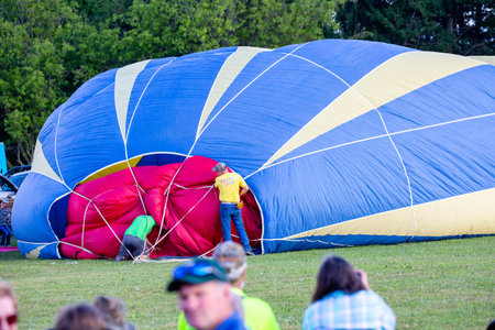 Marathon City, Wisconsin, USA, July 9, 2021, Taste N Glow Balloon Fest just West of Wausau.  People filling balloon with hot air, horizontalのeditorial素材