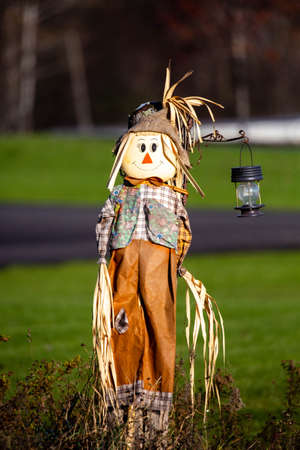 Cute scarecrow decoration with a lantern , verticalの写真素材