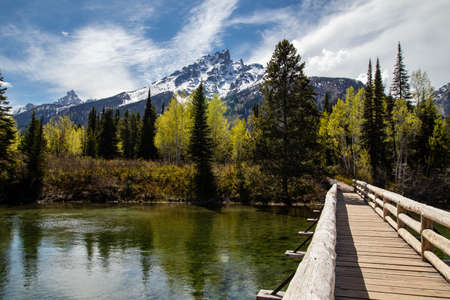 Jenny lake trail going over Cottonwood Creek and looking at Teewinot mountain in the Grand Tetons, horizontalの写真素材