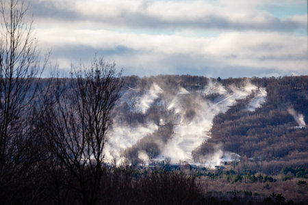 Snow cannons making snow on Granite Peak Ski Hill in Rib Mountain, Wausau, Wisconsin just before they open, horizontalの写真素材