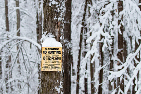 No hunting, no trespassing sign on a snowy tree in Wisconsinの写真素材