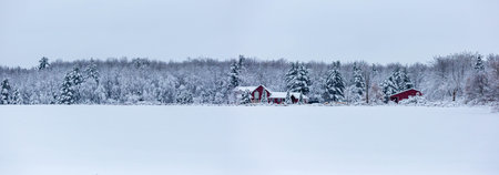 Red house after a December snow storm in Wisconsin, panoramaの写真素材