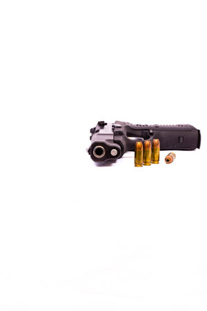 9mm pistol with hollow point bullets and white background with copy space, verticalの写真素材