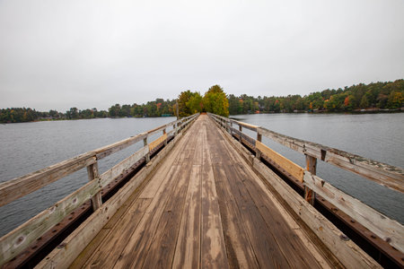 Bearskin Trailhead Bridge in Minocqua, Wisconsin over Lake Minocqua in September, horizontalの写真素材