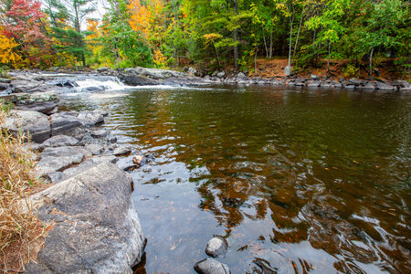 Waterfalls flowing into Lake of the Falls in Mercer, Wisconsin in September, horizontalの写真素材