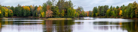 Waterfalls flowing into Lake of the Falls in Mercer, Wisconsin in September, panoramaの写真素材