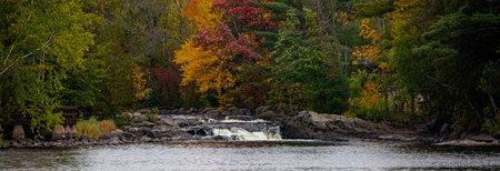 Waterfalls flowing into Lake of the Falls in Mercer, Wisconsin in September, panoramaの写真素材
