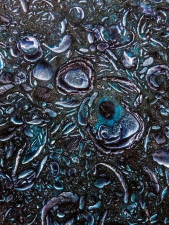 Abstract pattern of convex tiles of different lengths and shapes, in blue tones with iridescences of...