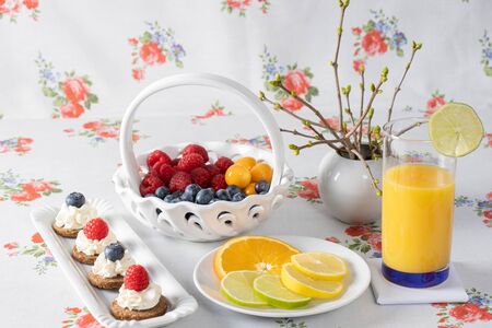 Various berries in a basket and cakes. On white background.の写真素材