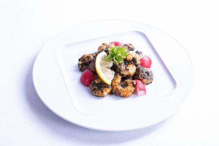 shrimp dish on a white plate on a white background