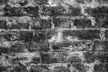 old black brick wall covered with salt in an old European city by the sea