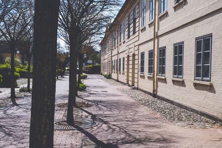 old building and stone street in european city in spring