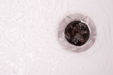 plum in the bathroom clogged with hair on a white backgroundの写真素材