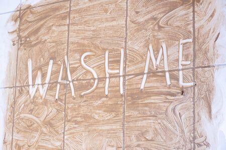 itâs written on the dirty wall in the bathroom, wash me on a white backgroundの写真素材