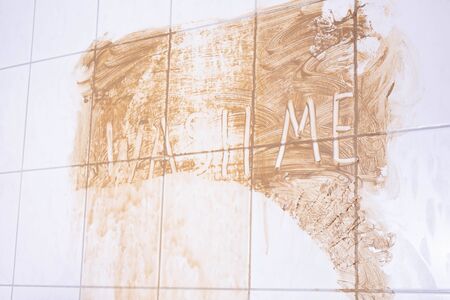dirty wall in the bathroom, where it says wash me on a white background