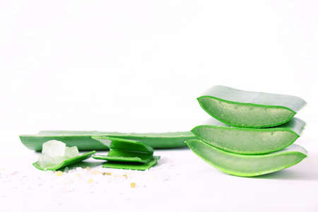 three pieces of aloe vera, juicy aloe pulp, diced, close-up on white backgroundの写真素材