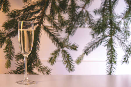 a full glass of champagne stands on the New Year's table on a white backgroundの写真素材