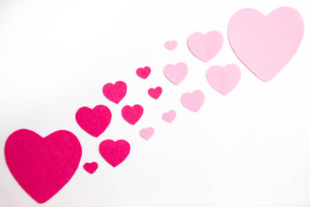 pattern of red and pink hearts lies on a white background, top viewの写真素材