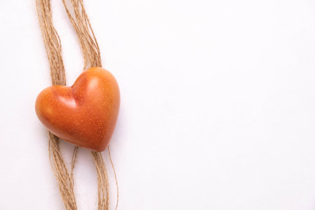 orange stone heart on a rope, on a white background, top viewの写真素材