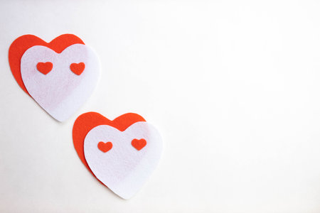 two red and white hearts lie on a white background, top viewの写真素材