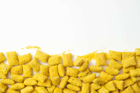 crispy cornflakes scattered on the table, on a white backgroundの写真素材