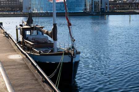 old fishing boat in the harbor of a big city, outside