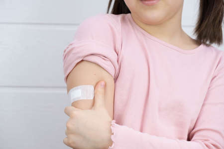 the child shows the place of vaccination, on a white background