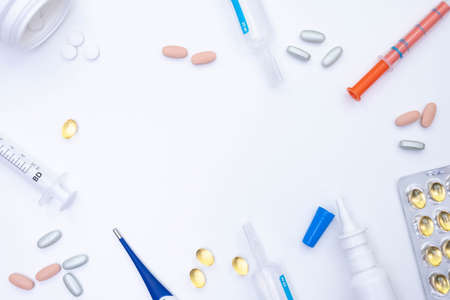 thermometer, pills of various medical items, on a white background