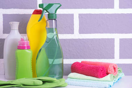 tools, gloves and rags for cleaning the house on a gray textured backgroundの写真素材