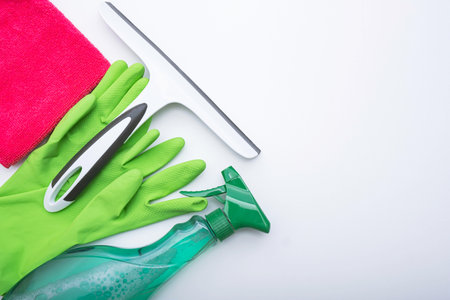 gloves, cleaning products, rag and window cleaning brush, white background and close-up