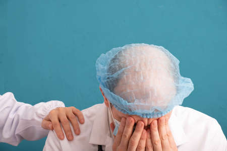 a nurse's hand on the doctor's shoulder, close-upの写真素材