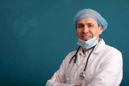 Nurse wearing cap and mask, stethoscope on shoulders, left side of blue background