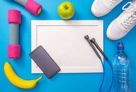 banana, water and apple, jump rope and white sneakers, cell phone and gazers, lie on the sides of...