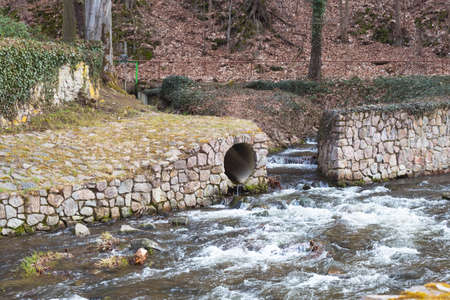 a shallow river, fast and bubbling, in a castle park, somewhere in Germany