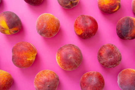 ripe peaches on pink background, close-upの写真素材