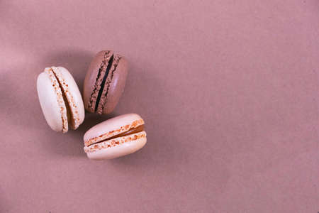macarons on a paper background, brown and beige background, pastel colorsの写真素材