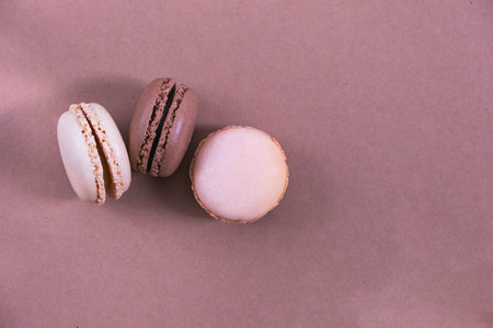 macarons on a paper background, brown and beige background, pastel colorsの写真素材