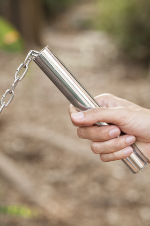 Women hands holding a nunchaku の写真素材