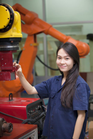 Manufacturing worker operating a robot machine 