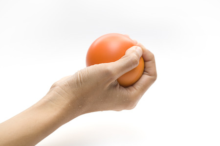 Hand squeezing a stress ballの写真素材
