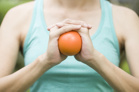 Hand squeezing a stress ballの写真素材