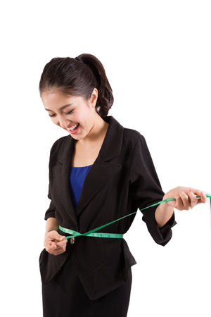 Young needlewoman taking measures of herselfの写真素材