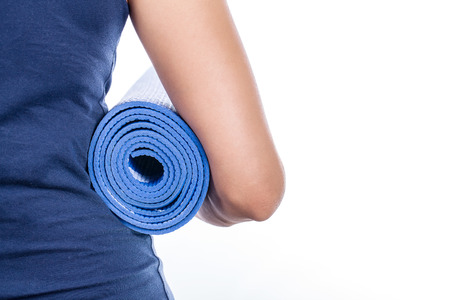 Young woman holding a yoga matの写真素材