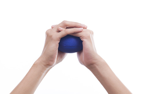 Hands of a woman squeezing a stress ballの写真素材