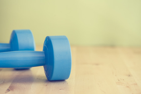 Two of dumbbells on the table- vintage style effect pictureの写真素材