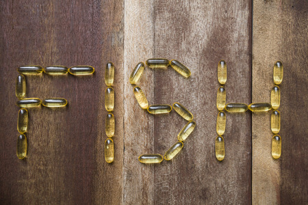 fish oil capsule on wooden backgroundの写真素材